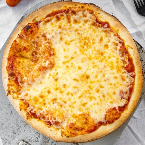 A whole Robola Pizzeria cheese pizza with a golden crust on a metal pan.