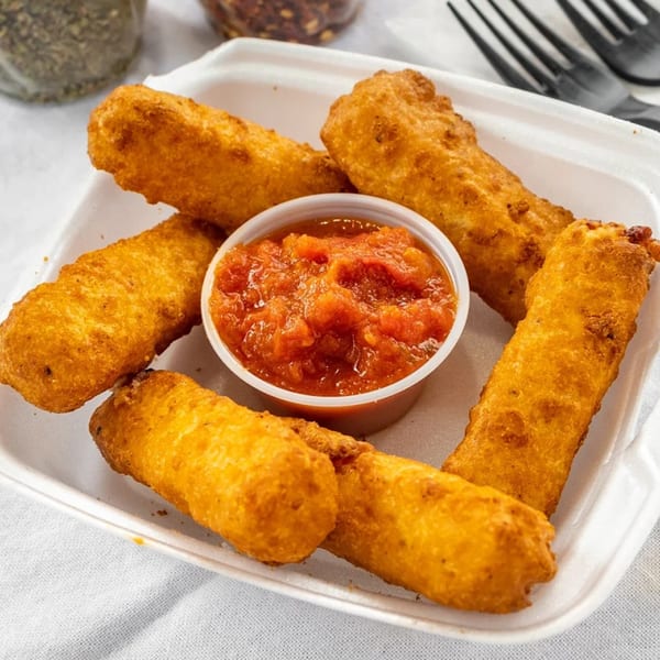 Golden-brown mozzarella sticks and a cup of red marinara sauce in a white takeout container.